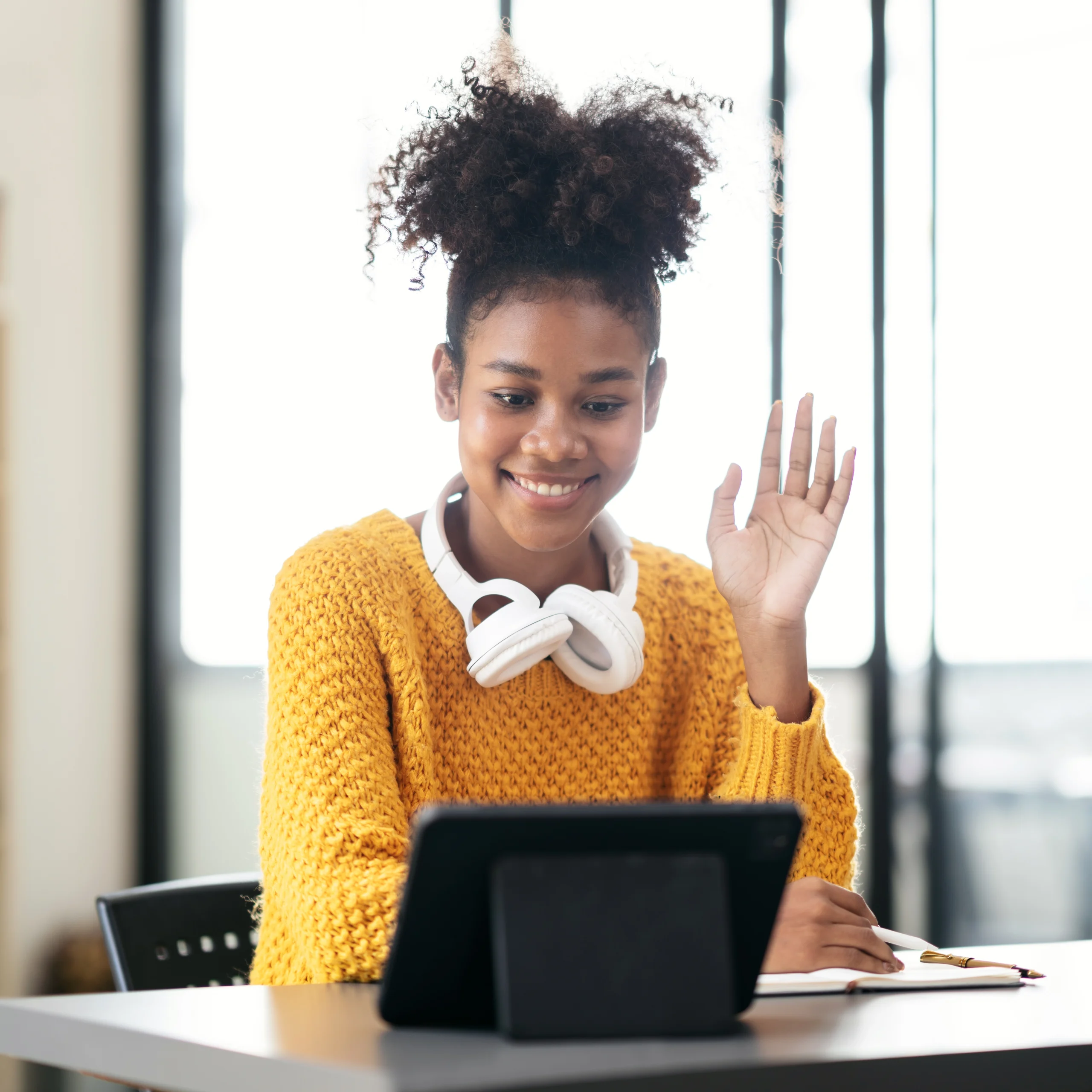 Illustration of a woman participating in online therapy, seated comfortably in her home and engaging with a therapist via video call on her laptop, highlighting the convenience and accessibility of virtual mental health care.